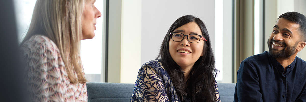 Three professionals in a meeting room