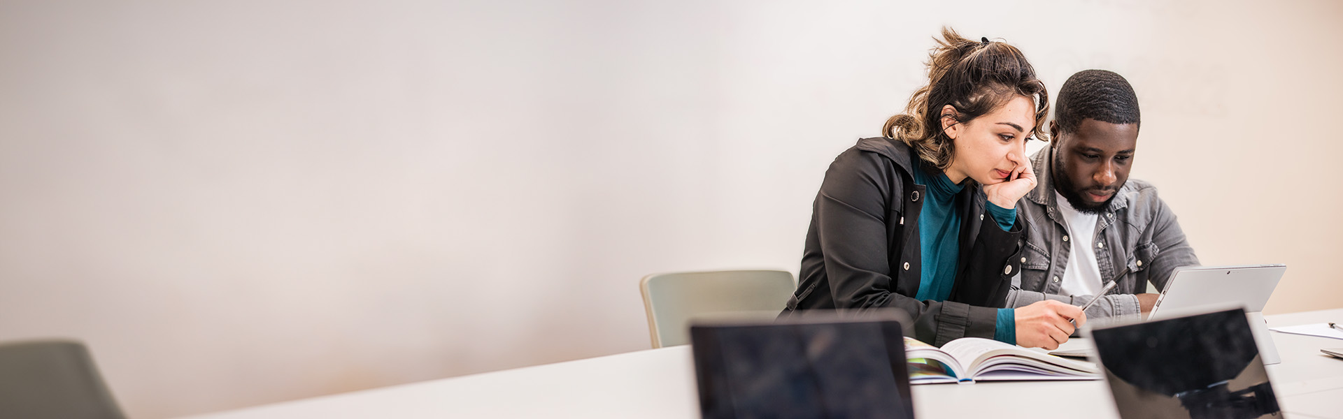 Pair of students using laptops