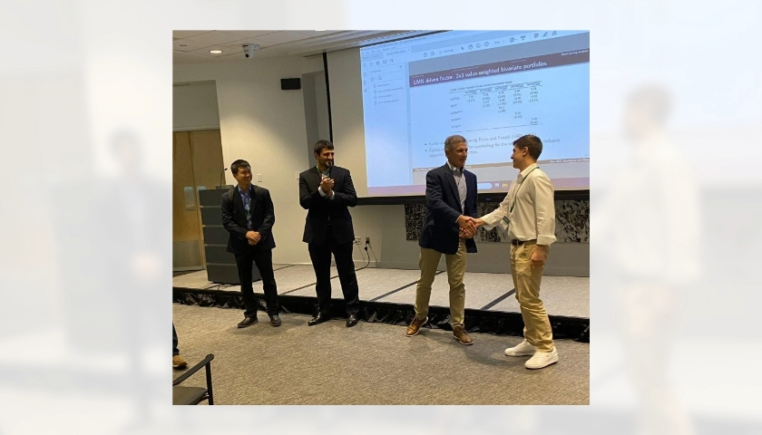 Photograph of competition winner receiving a certificate