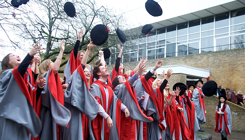 PhD graduates throwing their hats in the air
