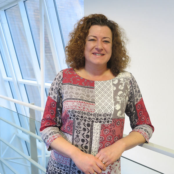 Alison leaning on a railing