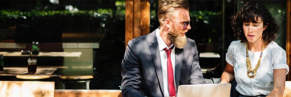 A man and a woman sitting outside talking