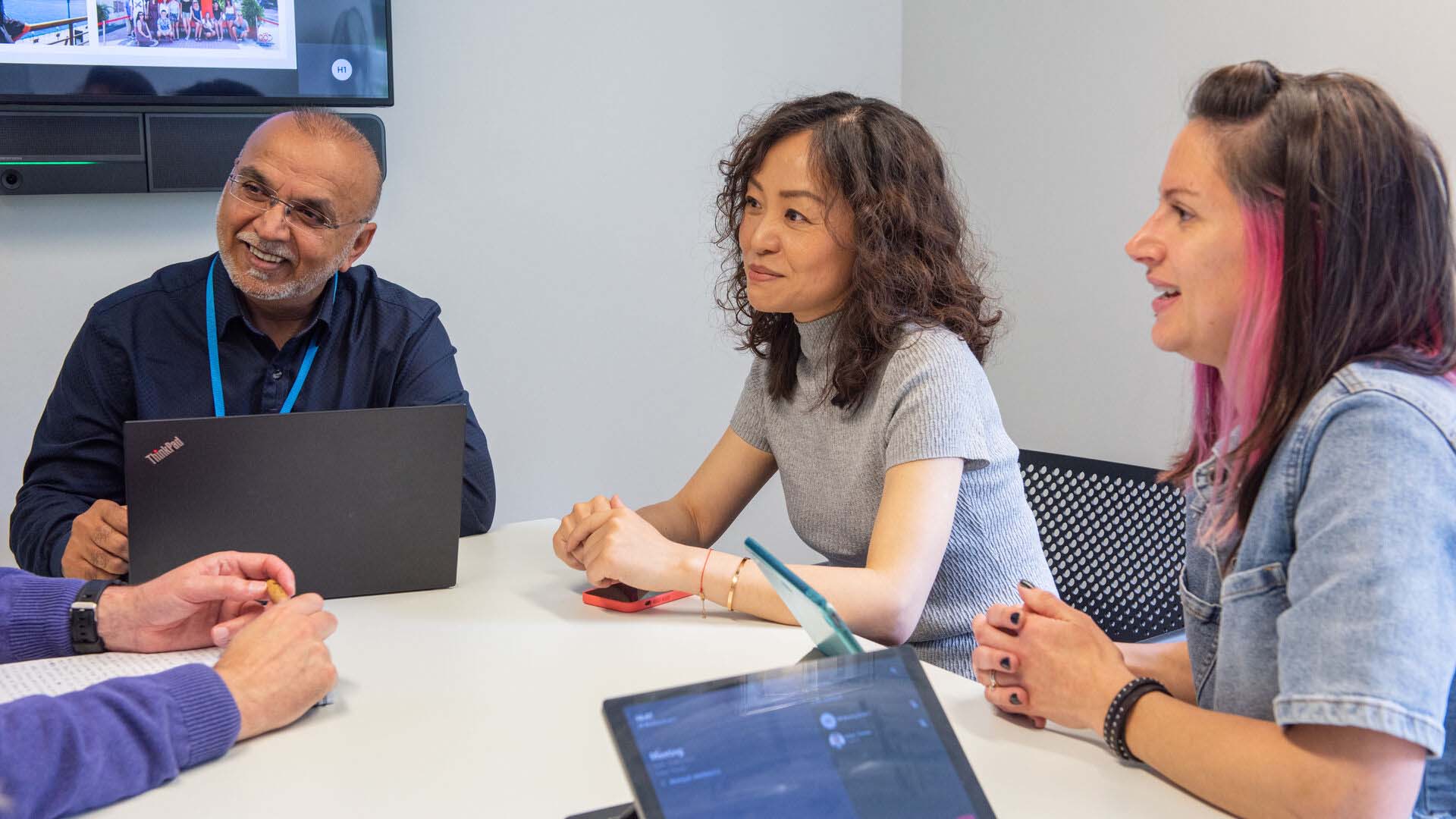 Group of professionals in conversation in a meeting room