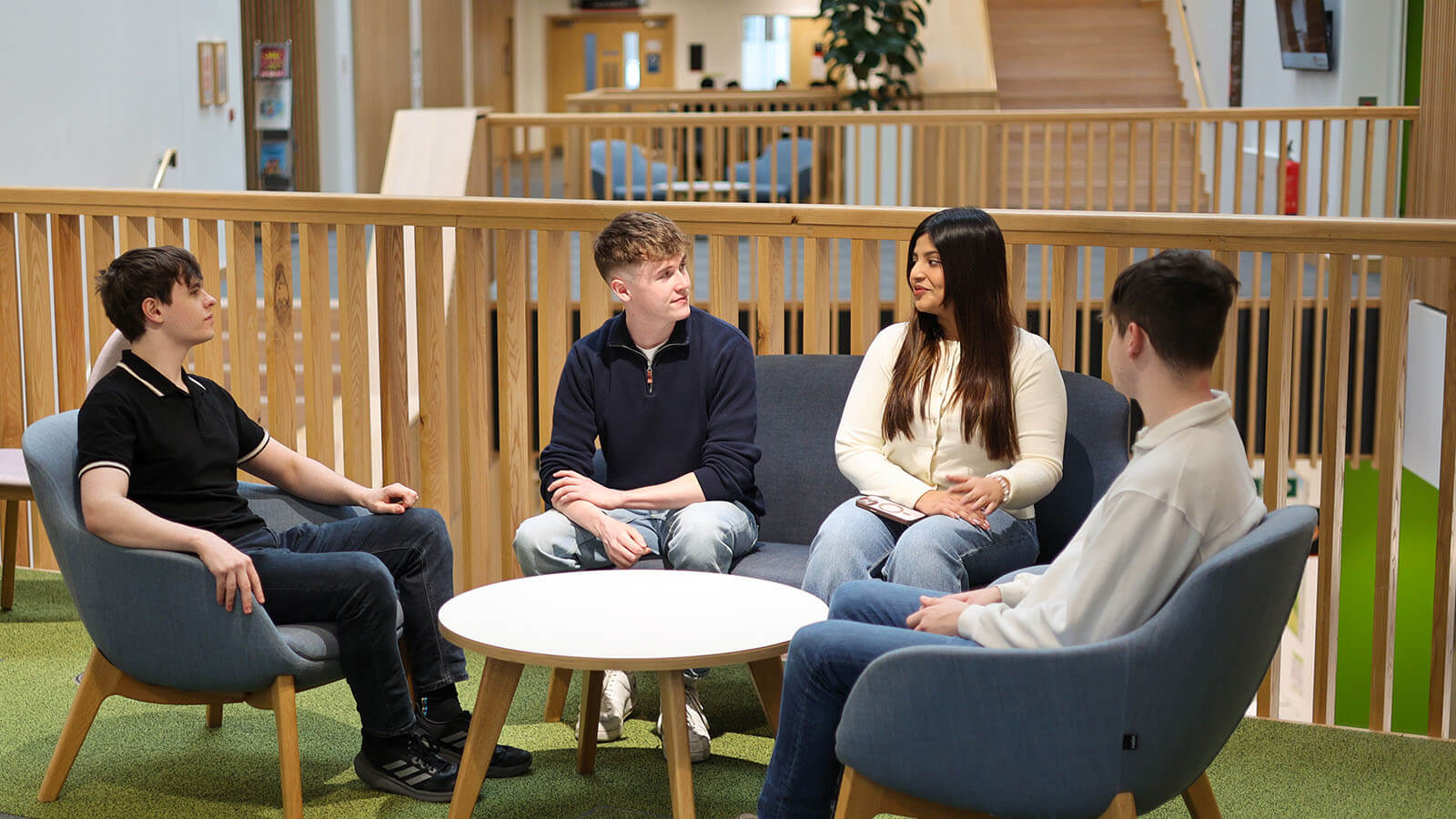 Entrepreneurship Society members in coversation in the Management School building