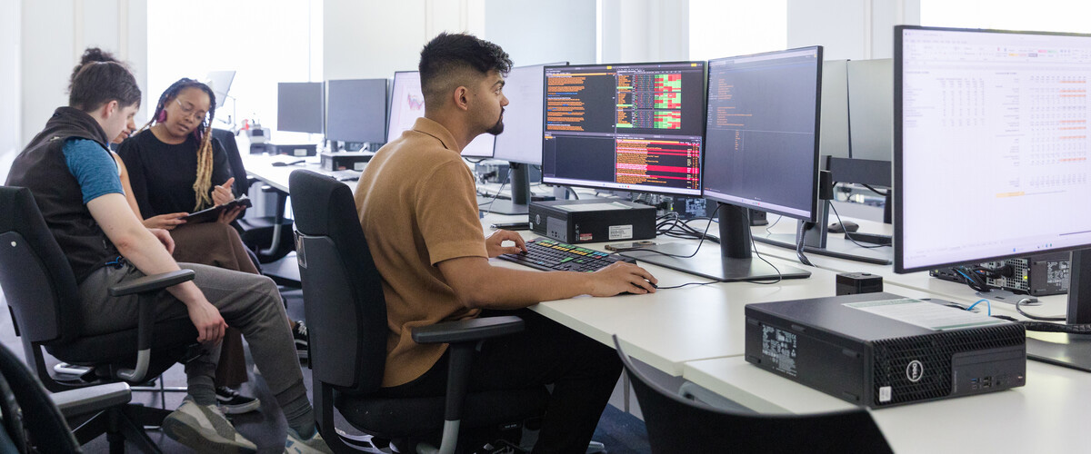 A postgraduate student working on a Bloomberg terminal