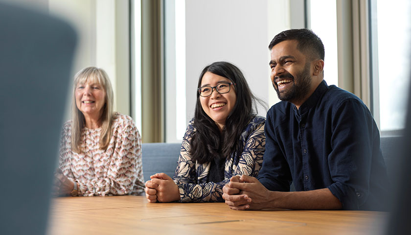 Three professionals in a meeting room