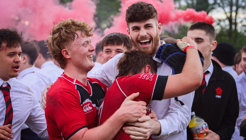 Rugby players celebrate victory in a Roses match