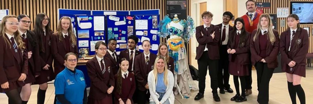pupils standing with a display board of their environmental work