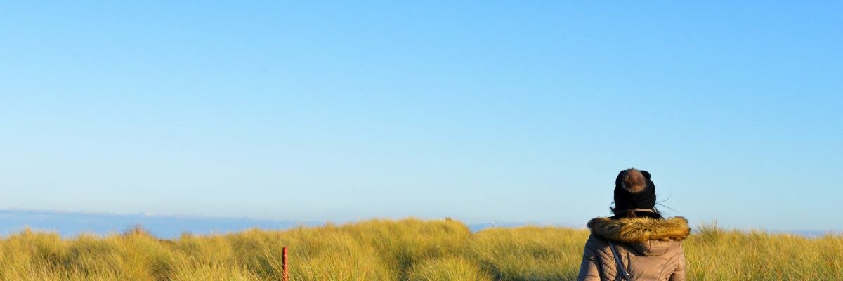 Pupil walking in the grasses near walney