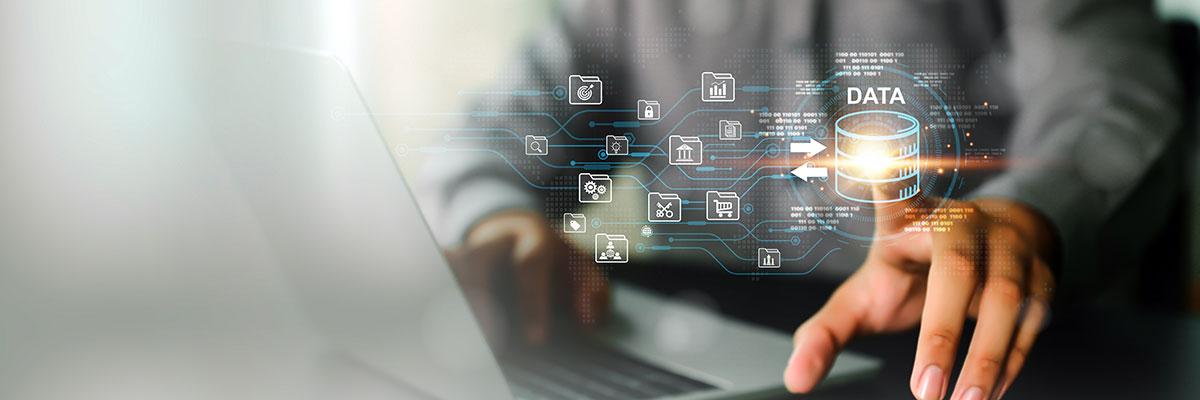 Open laptop with man pointing at a graphical representation of data.