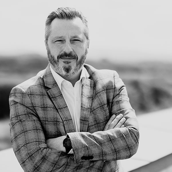 Kim Kaivanto standing on a balcony.