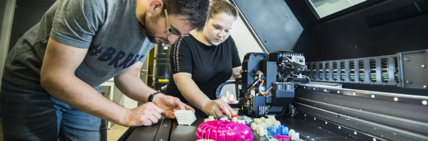 Engineering students work with the Stratasys J750