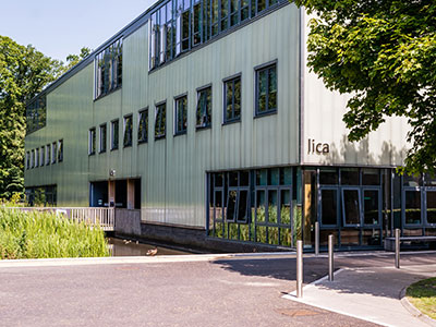 A building with a tree and foliage nearby
