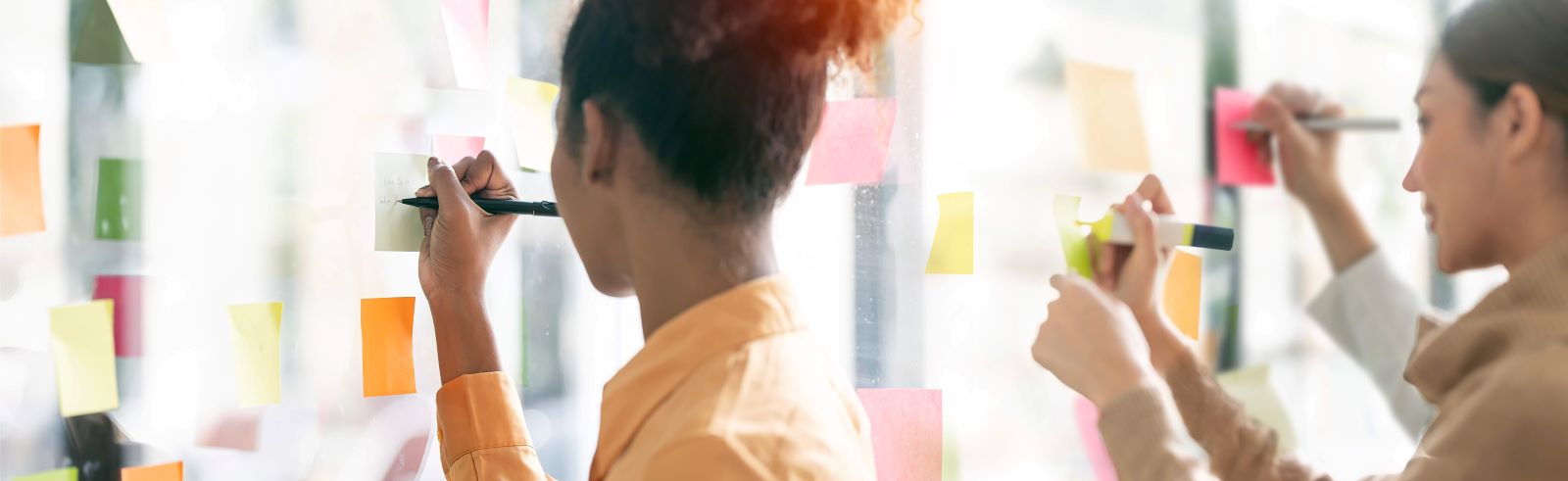 People writing on post it notes.