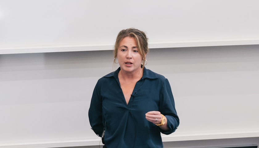Dr Georgiana Allison speaking at the front of a lecture theatre