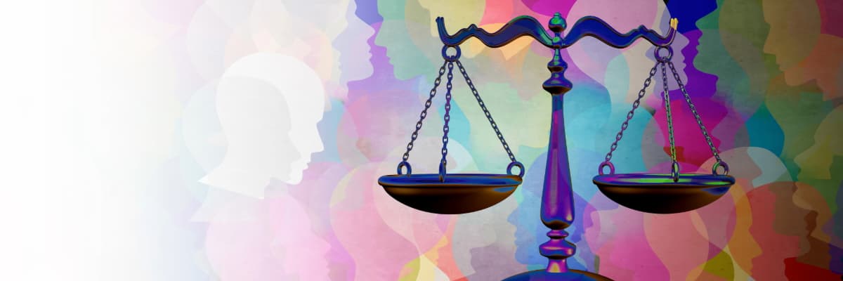 Someone dressed in pink, we see their hands holding small blue boots
