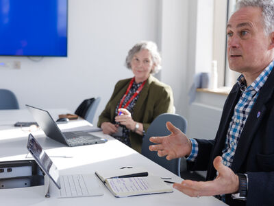 man and woman in a meeting having a discussion