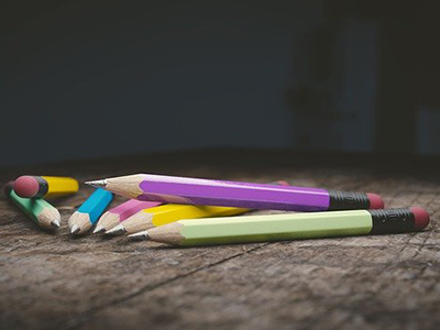 A selection of coloured pencils on a wooden surface