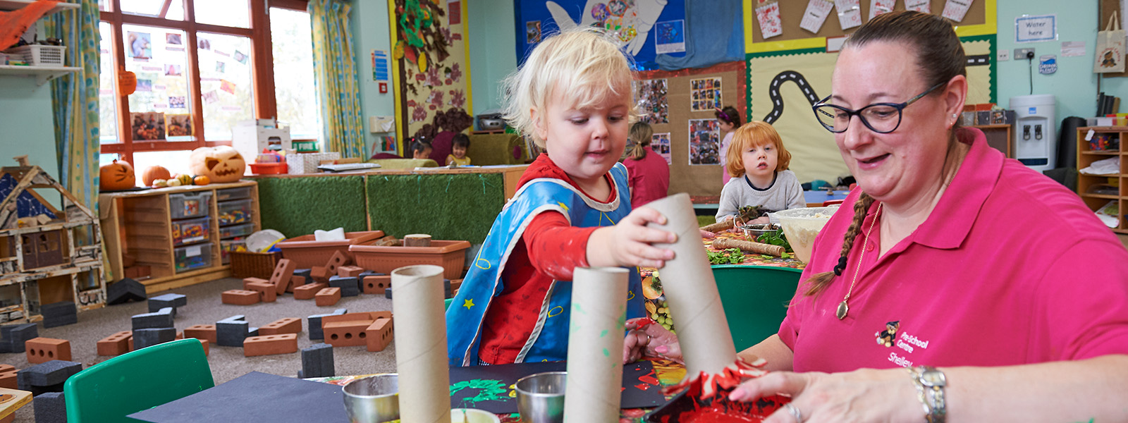 Key person and child painting with shapes