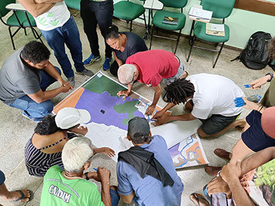 Children working together as a team, discussing forest restoration