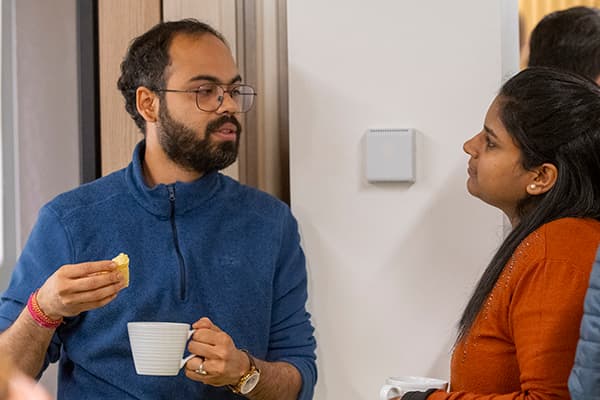 Two researchers chatting over coffee 