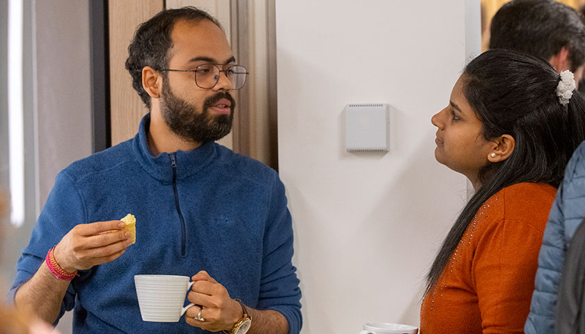 Two people talking over a cup of coffee