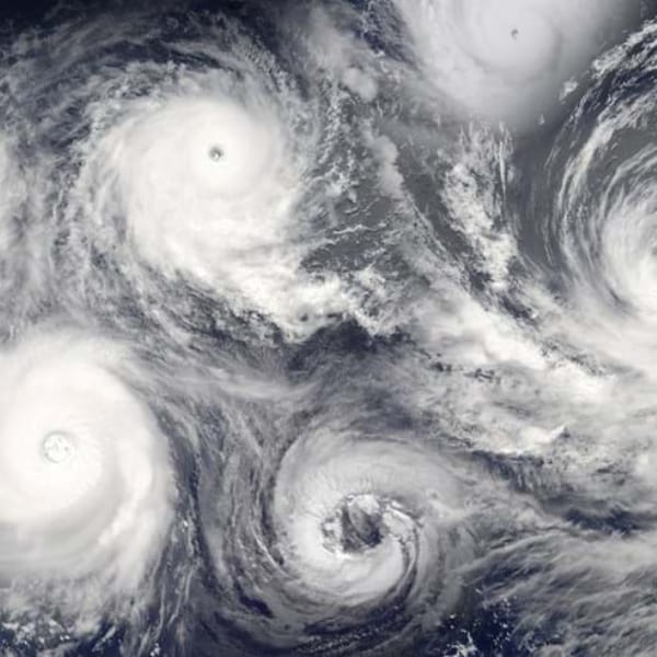 A series of overlaid hurricanes, viewed from above