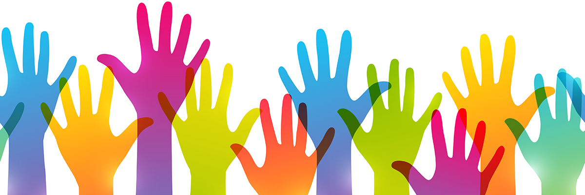 Hands in different colours being held up 