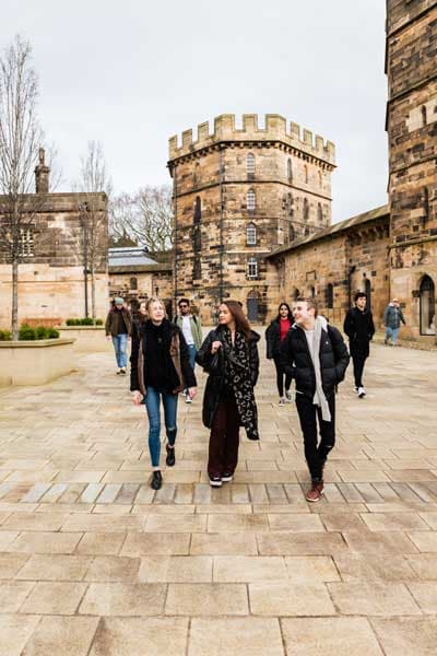 Group of students walking in the castle courtyard
