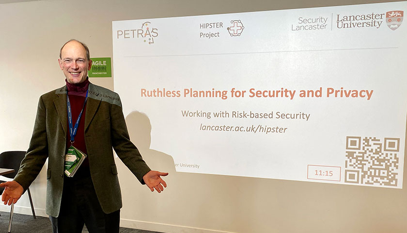 A man in front of a presentation