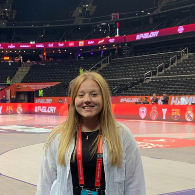 Ellie inside a basketball arena