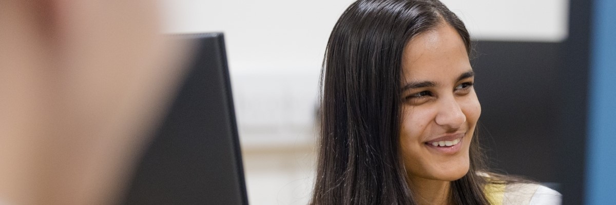 A STOR-i student smiling off to the right-hand side of the screen