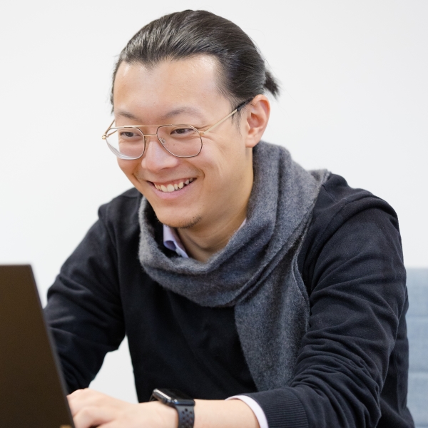 Student smiling at a laptop
