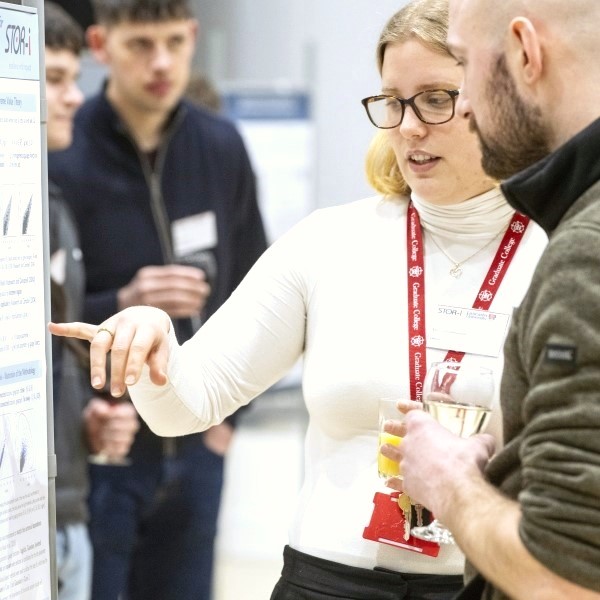Student showing off a research poster at the STOR-i conference