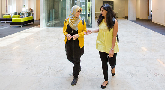 picture of 2 students walking round campus 