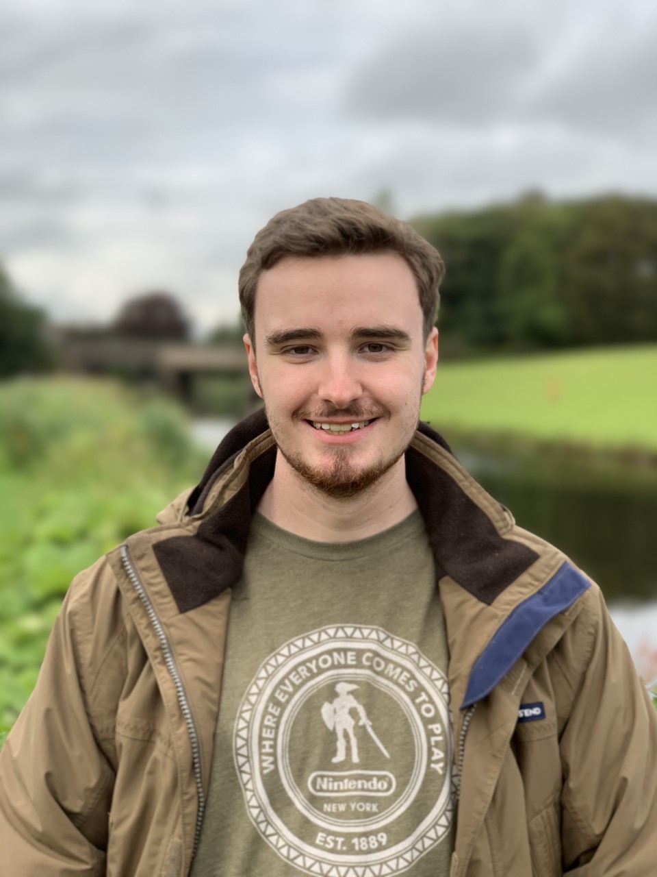 A male student smiling at the camera. 