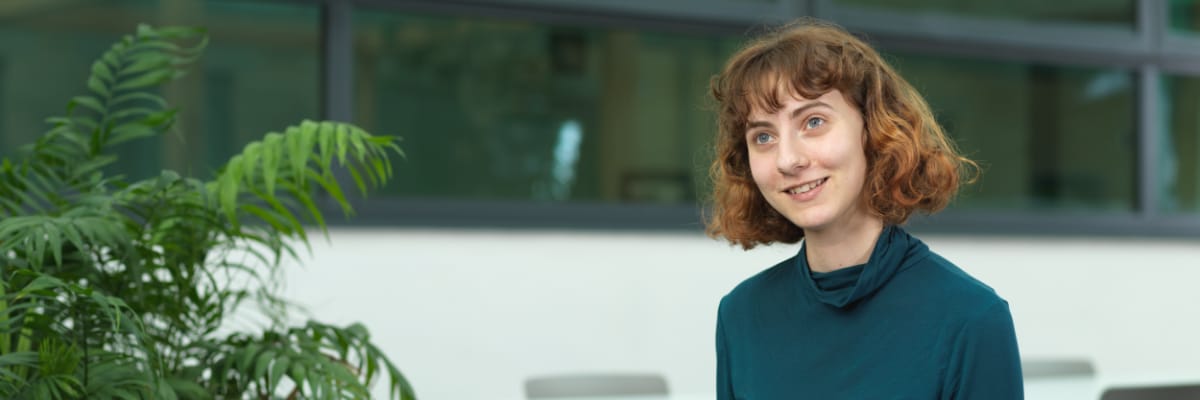 A student sits talking to someone off camera.