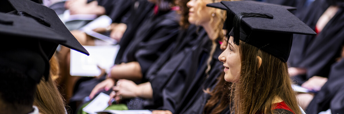 A row of students sat in a graduation ceremony.