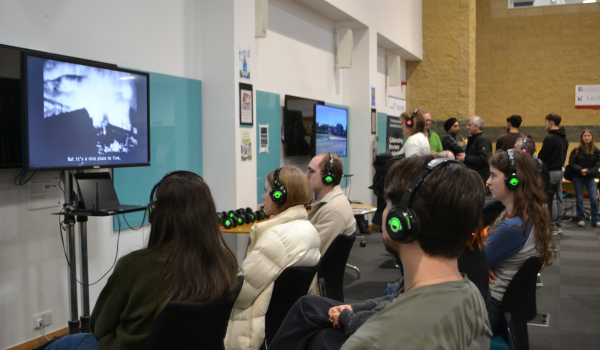 Students watching a screen