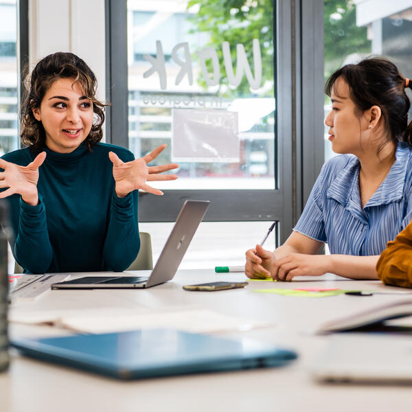 Two staff members discussing a topic together