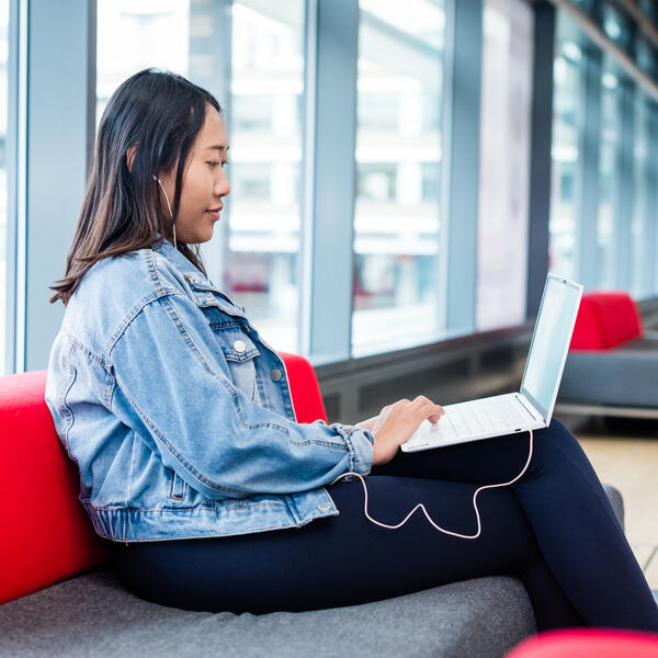 Student sat at a laptop 