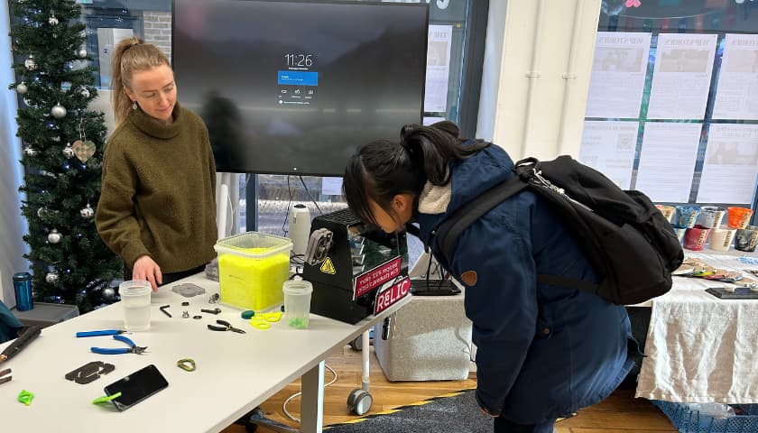 Student making a recycled plastic phone stand