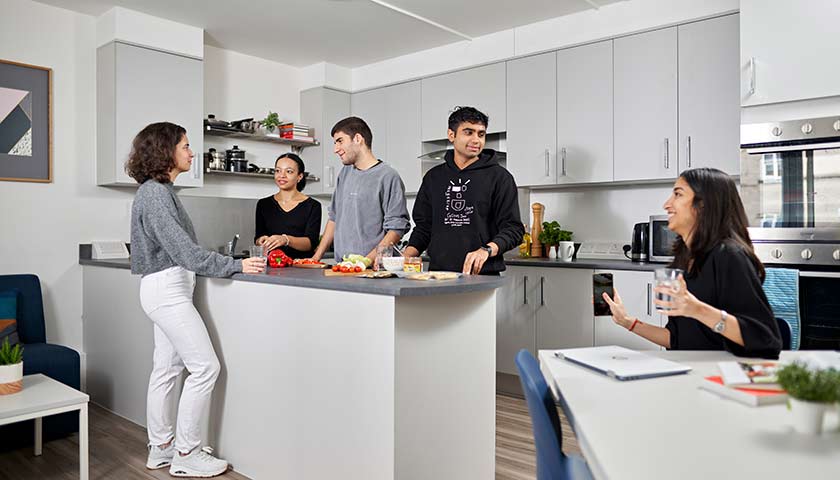 Group of students cooking together in student accommodation on Lancaster University campus