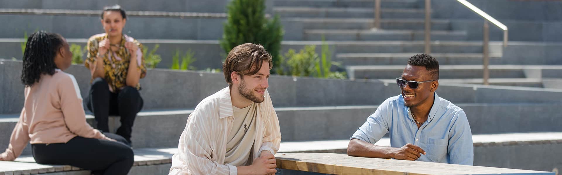 Students sat in Edward Roberts Court in the sunshine
