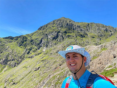 Ewan stood at the foot of a mountain