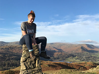 Katie sat on a rock, smiling