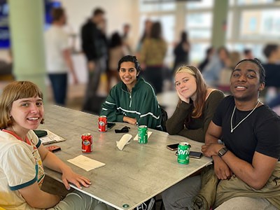 LSP students sat round a table during an end of year social event
